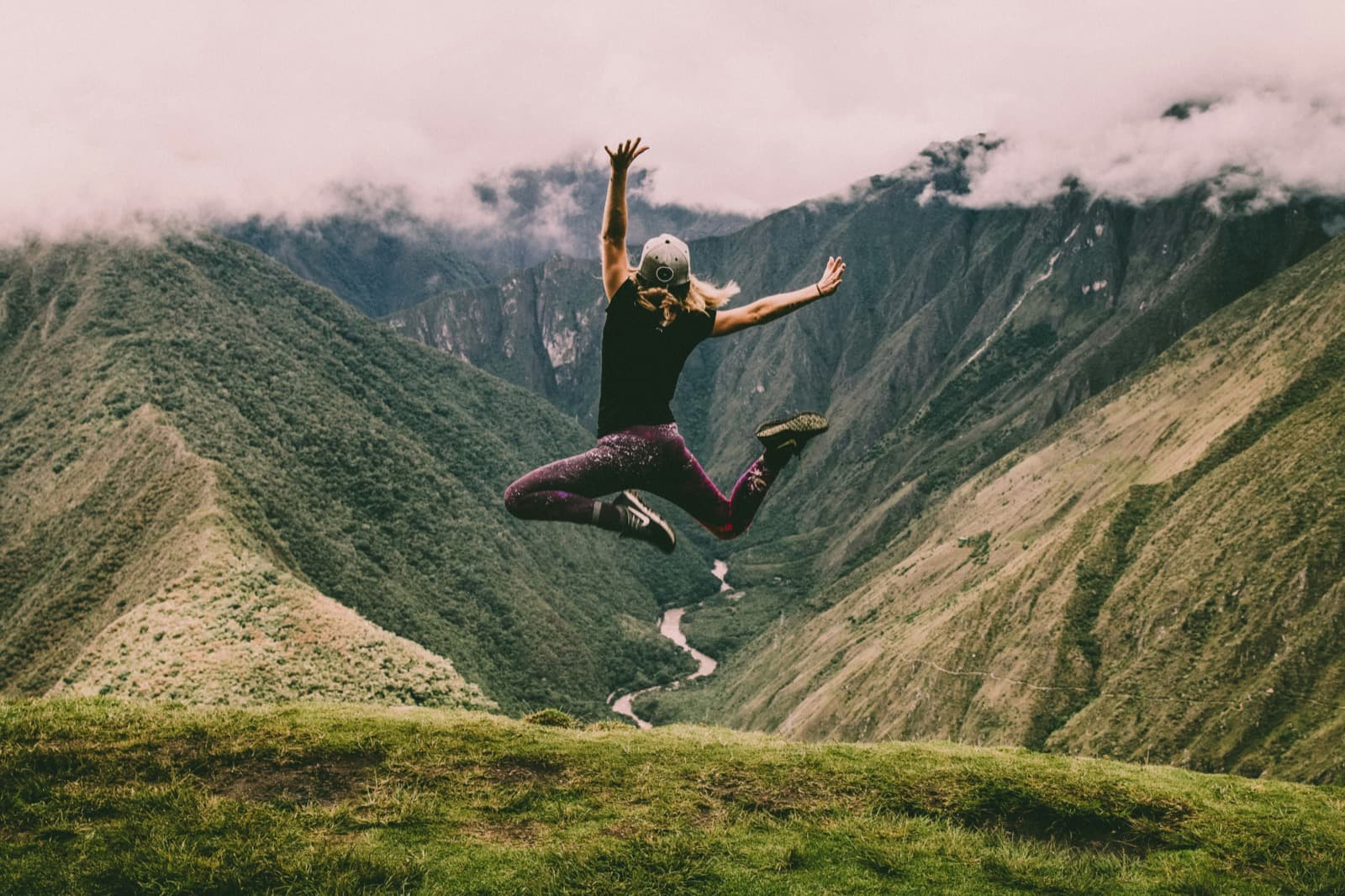 Active person jumping freely in nature — representing life after pain management